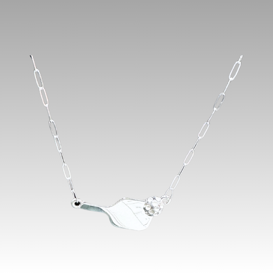 Silver necklace with a unique pendant on a light gray background