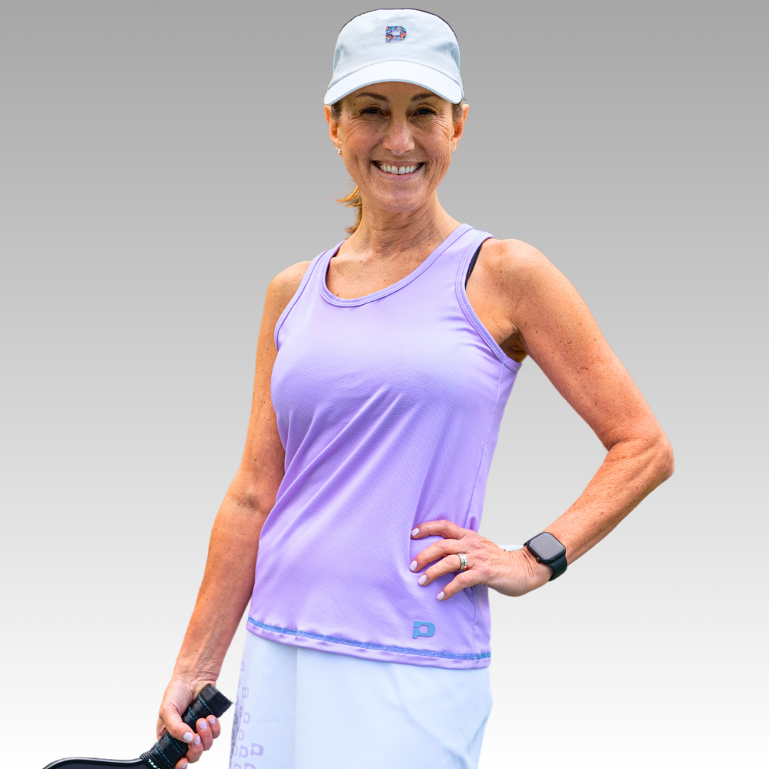 Woman in purple tank top with white cap
