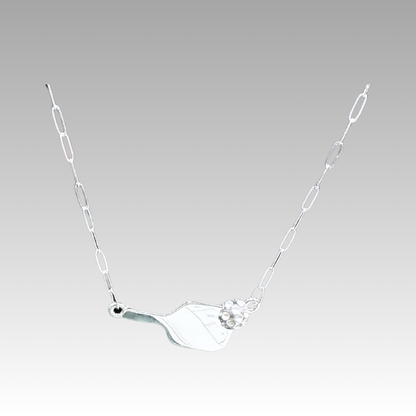 Silver necklace with a unique pendant on a light gray background