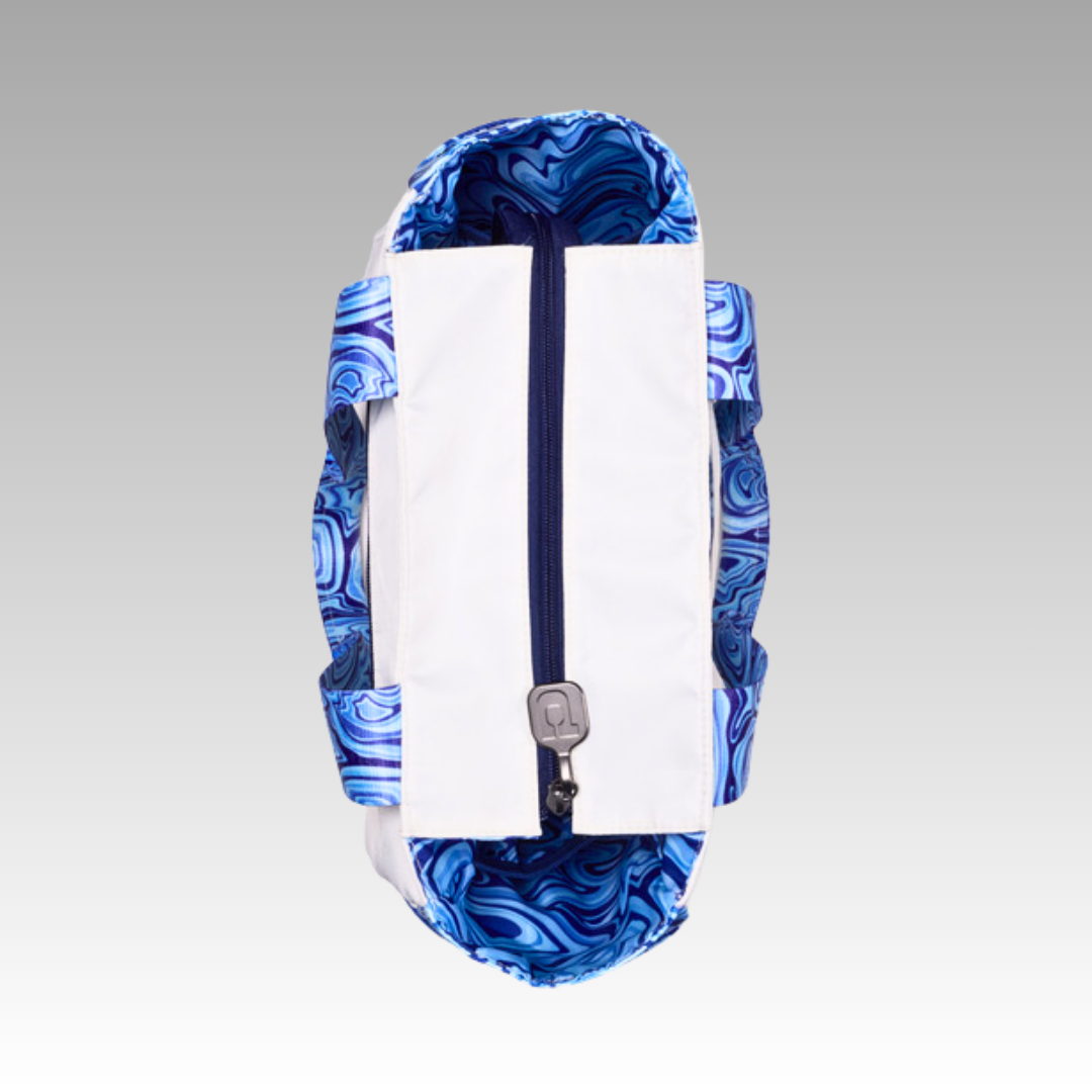 Blue and white patterned pickleball tote with a zipper on a gray background.  Top of the bag view