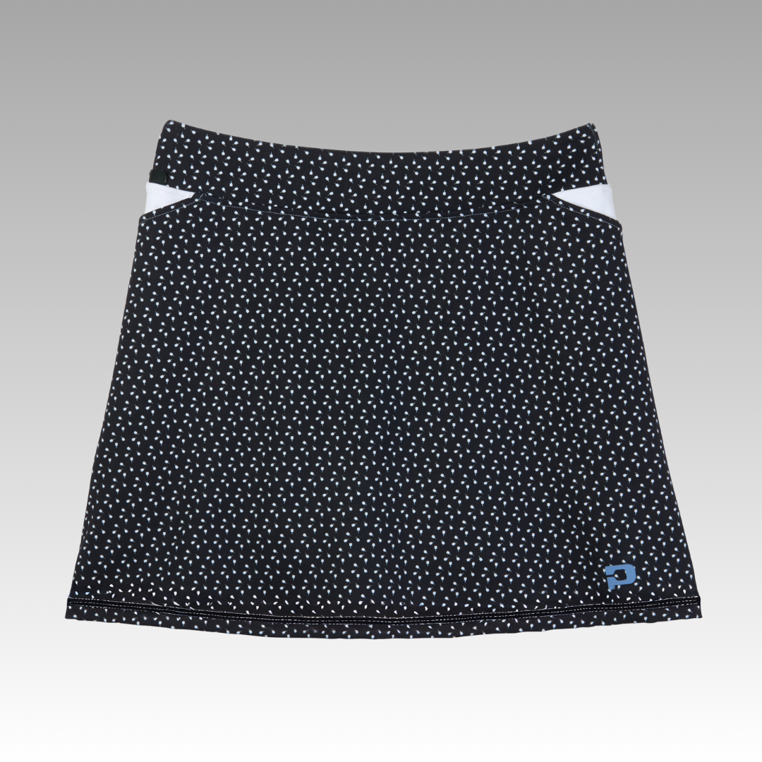 Black polka dot pickleball skort with a brand logo on a gray background