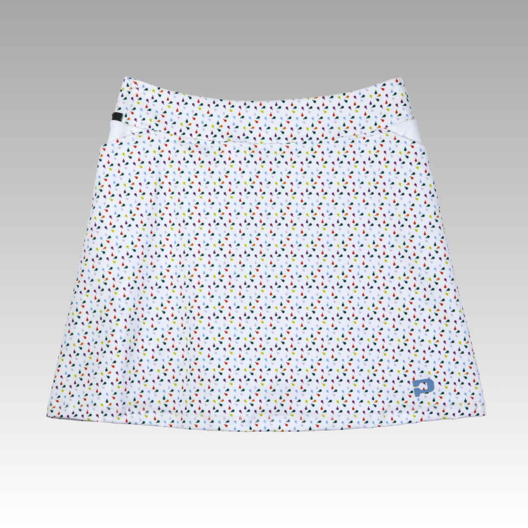 White skirt with colorful polka dot pattern on a gray background
