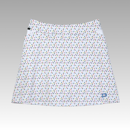 White skirt with colorful polka dot pattern on a gray background