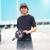 Young man wearing black pickleball shirt and hat